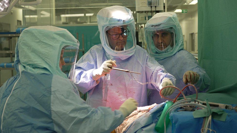 Consultant orthopaedic surgeon Henry Wynn Jones and team operate on patient Sandra Haughton