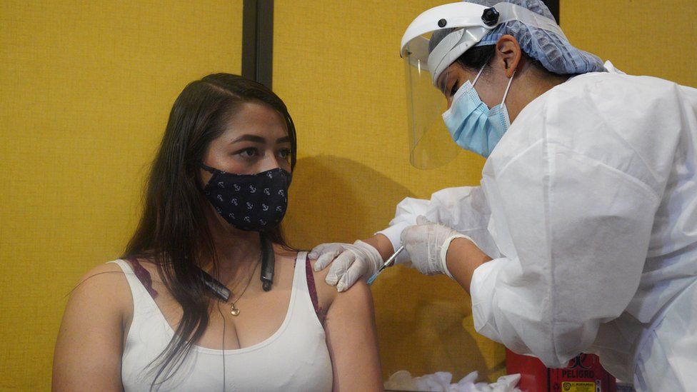 Johana Bautista, 26, gets vaccinated at a conference centre in Bogotá