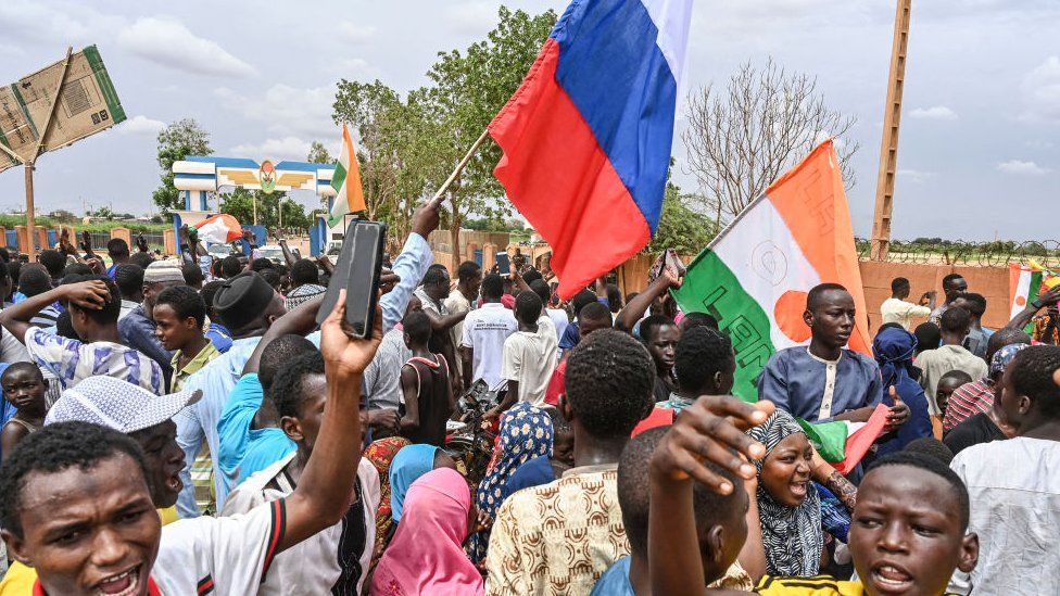 A Russian flag being waved amid a crowd in Niger