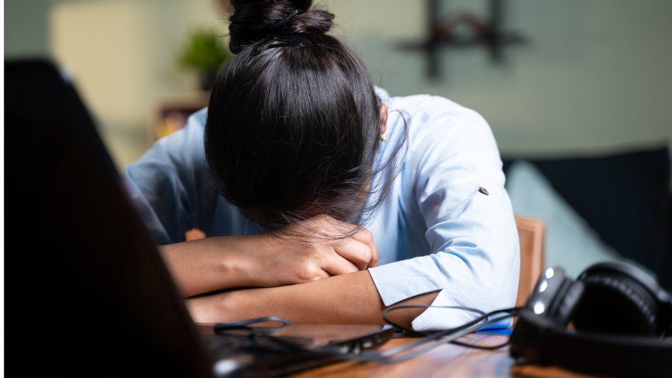 young Business woman sleeping by closing laptop while working, concept of new normal burnout, over or late night work at home during coronavirus covid-19 pandemic.