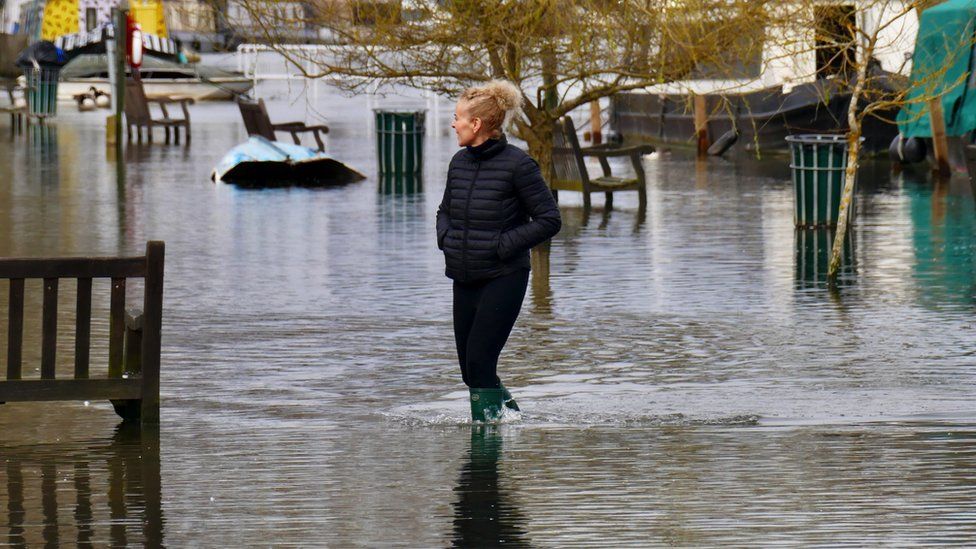 Woman walking in flood water