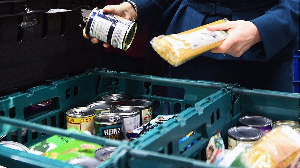 Person sorting food in a food bank