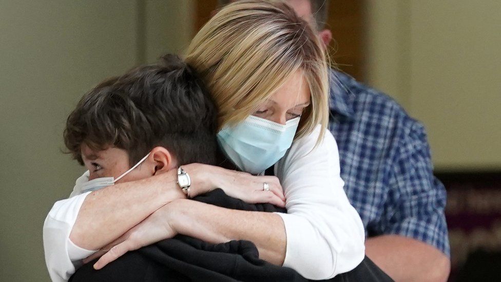 Elaine Burt hugs her nephew after he lands at Glasgow Airport