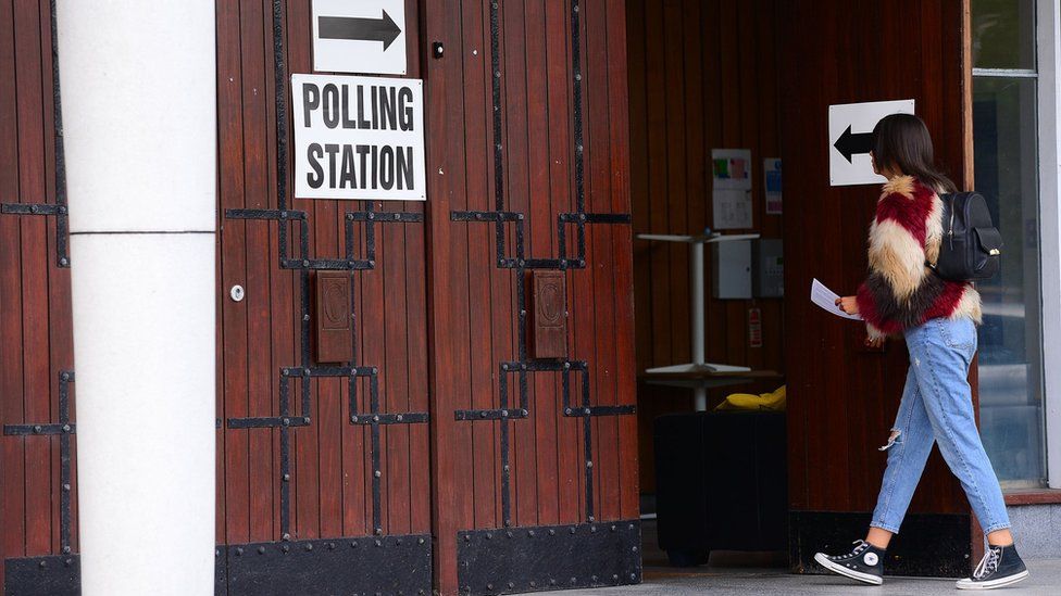 woman entering polling station