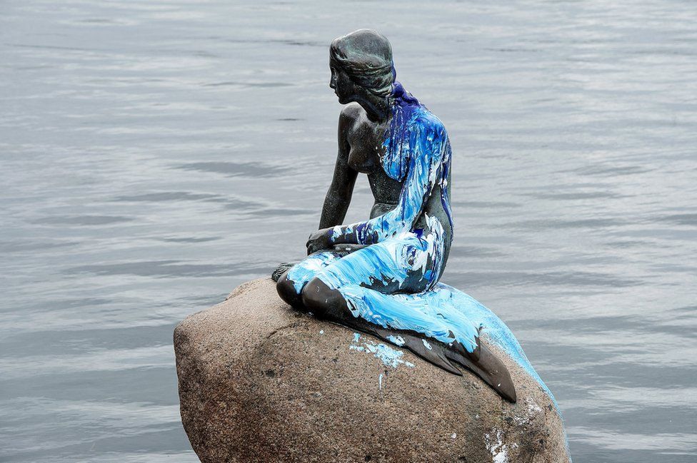 The Little Mermaid statue is covered with blue and white paint in Copenhagen, Denmark, 14 June 2017.