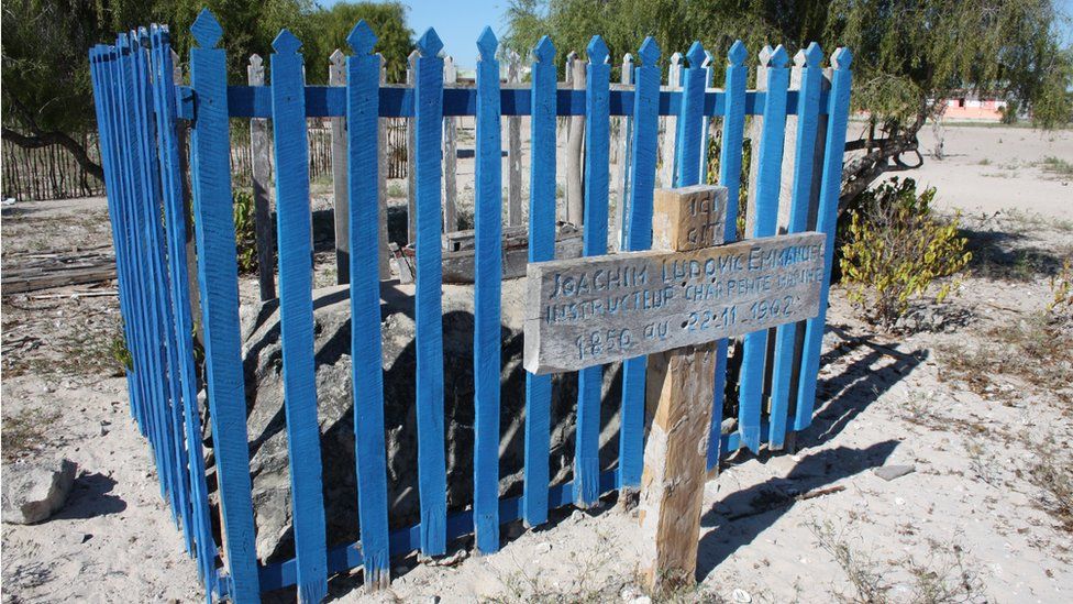 A wooden cross and blue picket fence mark the grave of shipbuilder Ludovic Emmanuel Joachim who died in 1902.