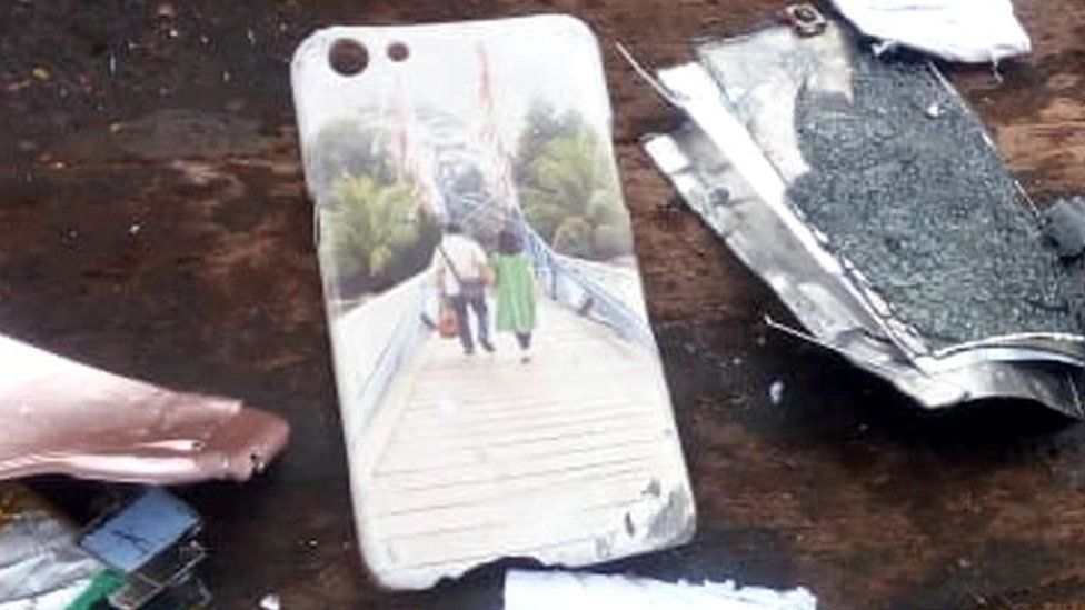Damaged phone and phone case showing a couple walking across a bridge