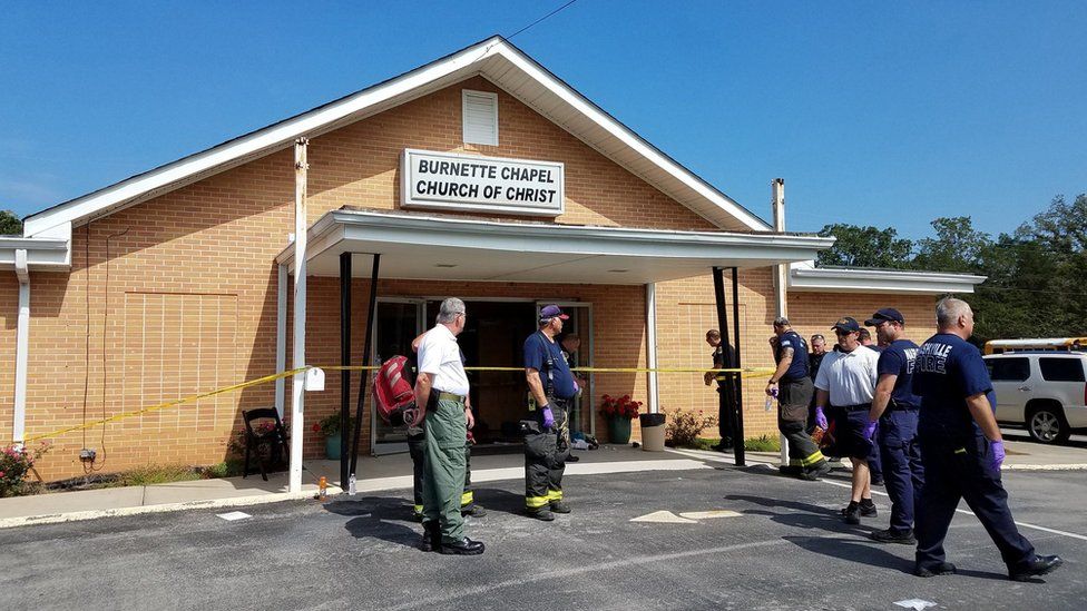 The Burnette Chapel Church of Christ - a low brick building with white eaves, surrounded by emergency workers and encircled in police tape