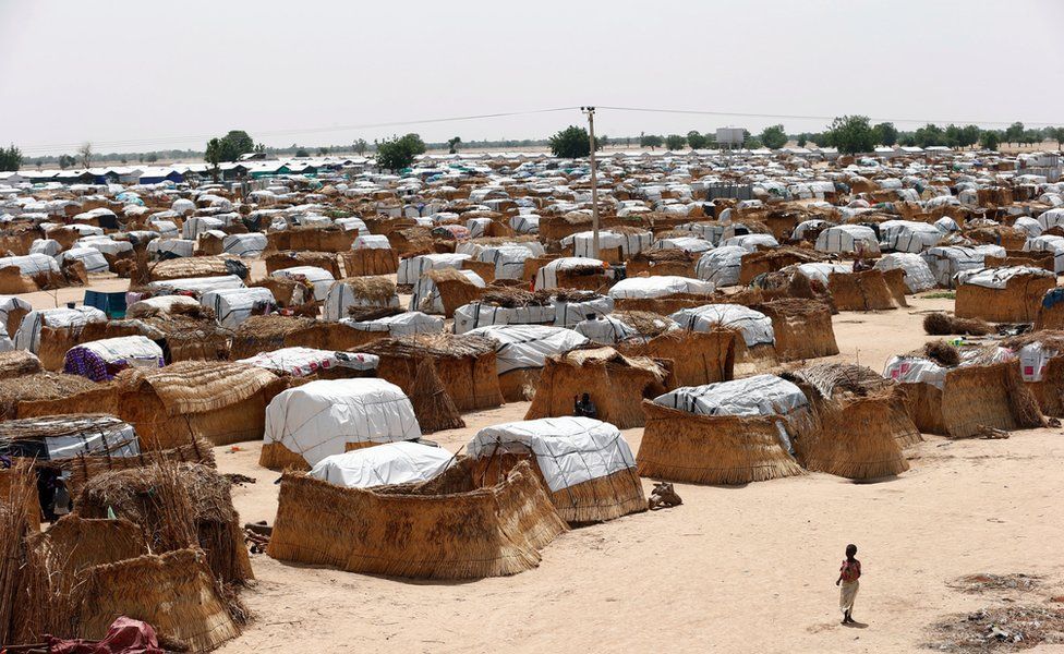 A girl walks through makeshift sheds at an internally displaced persons (IDP) camp on the outskirts of Maiduguri, northeast Nigeria June 6, 2017.