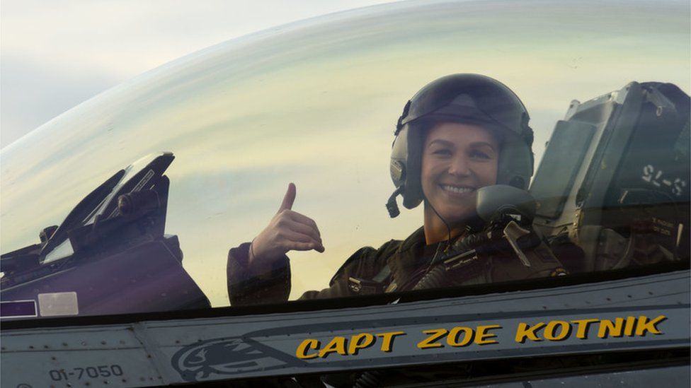 Capt Zoe "SiS" Kotnik sits in her fighter plane