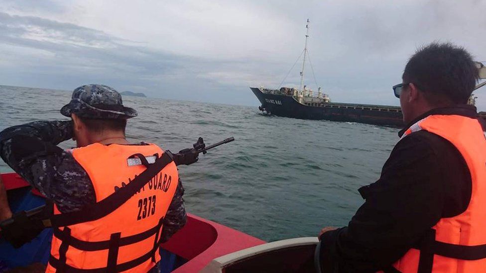 Armed Philippine Coast Guard personnel escort Vietnamese vessel MV Giang Hai, which was attacked by pirates, to Taganak anchorage area in Tawi-Tawi, southern Philippines, on 21 February 2017.