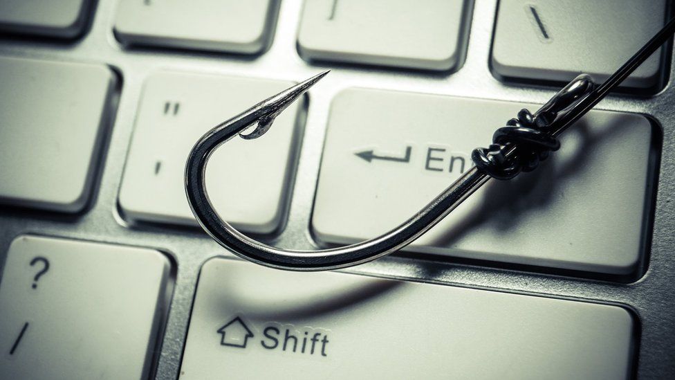 Fishing hook on a computer keyboard