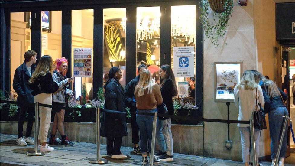 People queue at a pub in Birmingham, ahead of a national lockdown for England from Thursday.