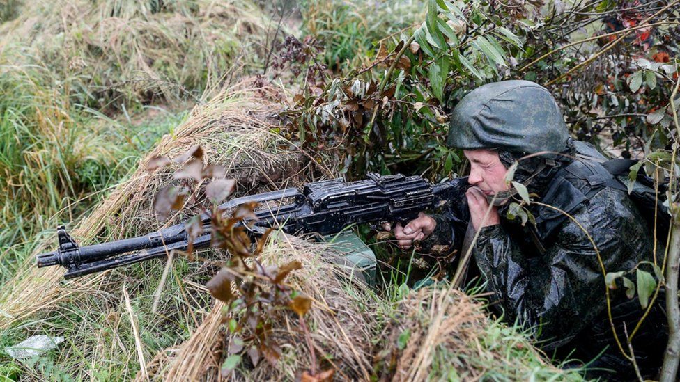 A handout photo from the Russian Defence Ministry shows a soldier aiming his weapon from a position, during the 2017 Zapad military exercises