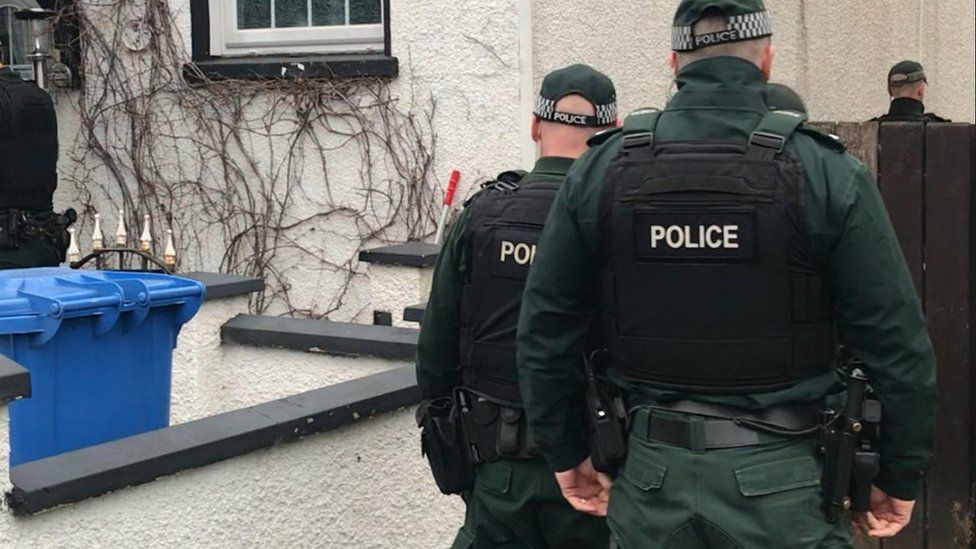 Police officers involved in the raids in east Belfast