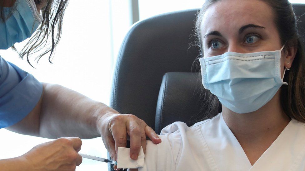 A medical staff member receives a dose of the Pfizer-BioNTech coronavirus disease (COVID-19) vaccine at the CHIREC Delta Hospital in Brussels, Belgium January 21, 2021