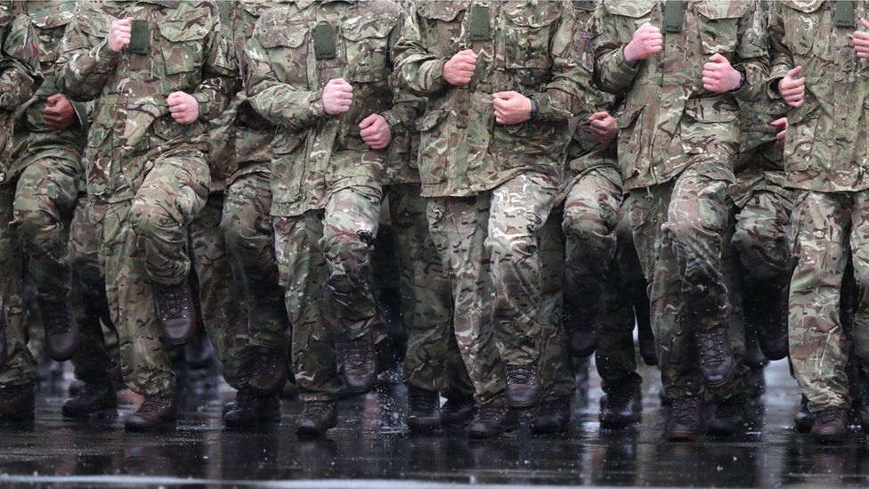 Soldiers marching in the rain at Normandy Barracks