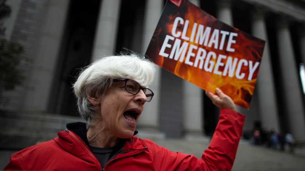 A climate change protester outside the New York State Supreme Court building on the first day of the ExxonMobil trial on 22 October, 2019