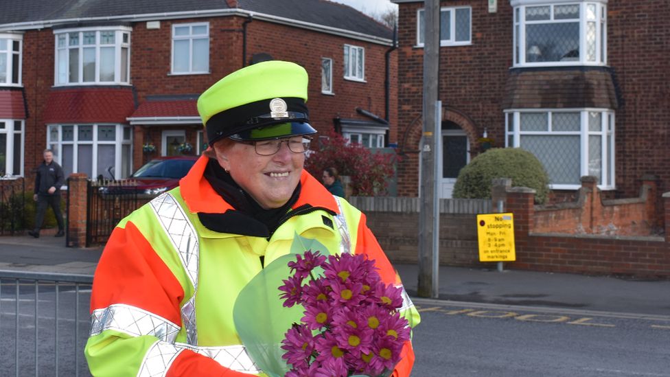 Beryl Quantrill holding a bouquet of flowers