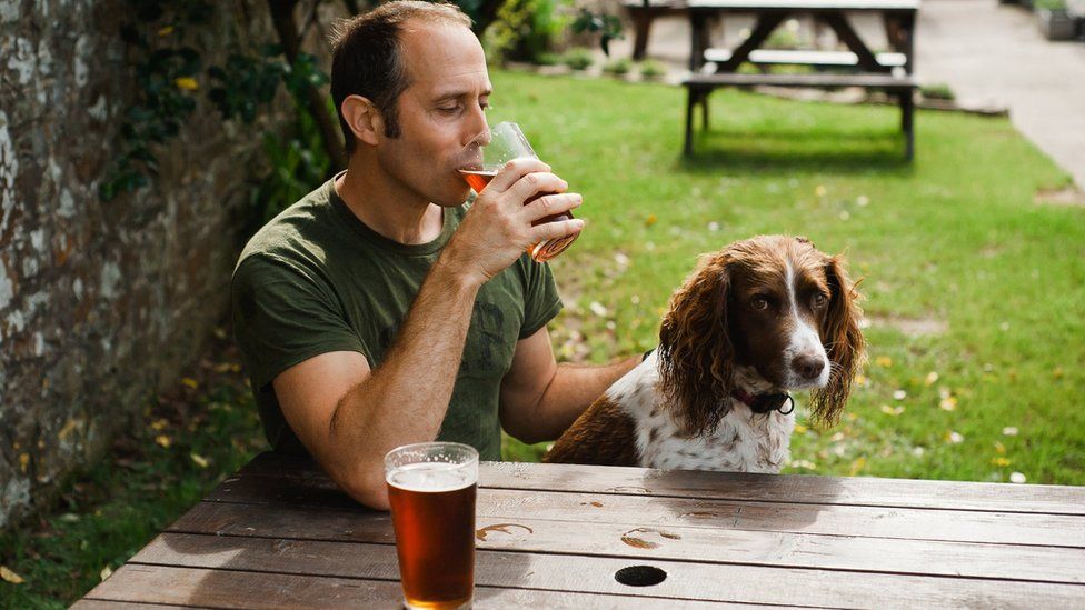 Man with dog in pub