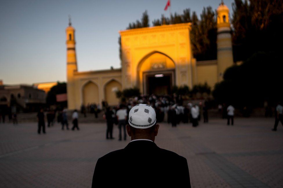 This picture taken on June 26, 2017 shows a Muslim man arriving at the Id Kah Mosque for the morning prayer on Eid al-Fitr in the old town of Kashgar in China's Xinjiang Uighur Autonomous Region.
