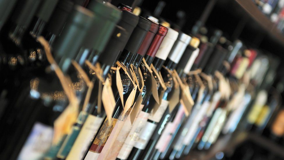 Row of bottles of wine on shelf