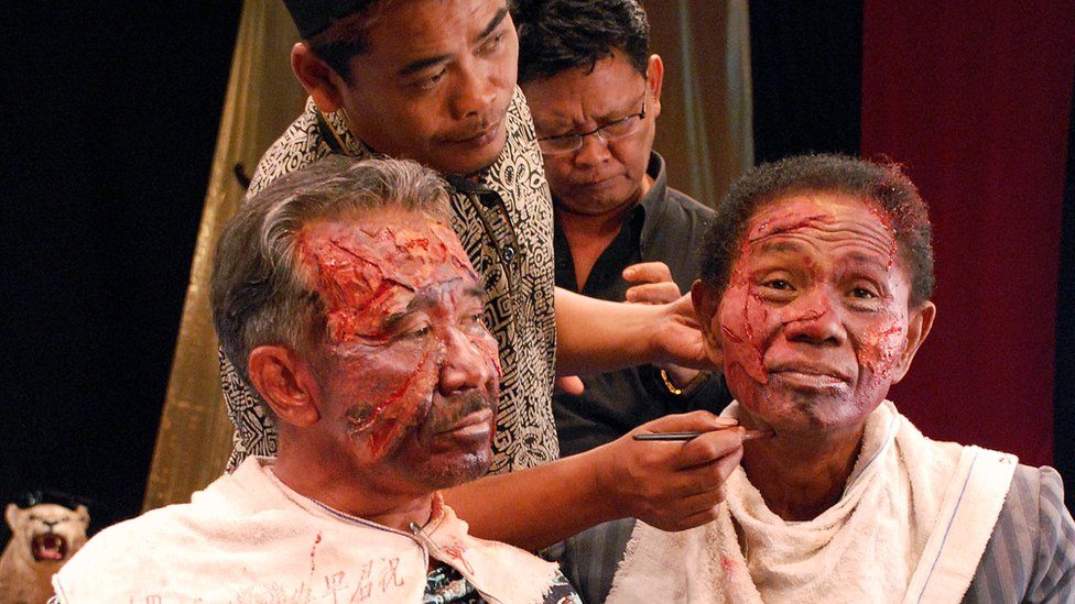 Anwar Congo (R) is given make-up during the filming of the Oscar-nominated documentary The Act of Killing