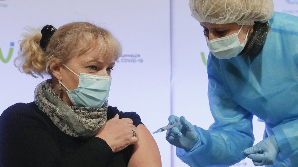 A Ukrainian medical worker receives a doze of AstraZeneca