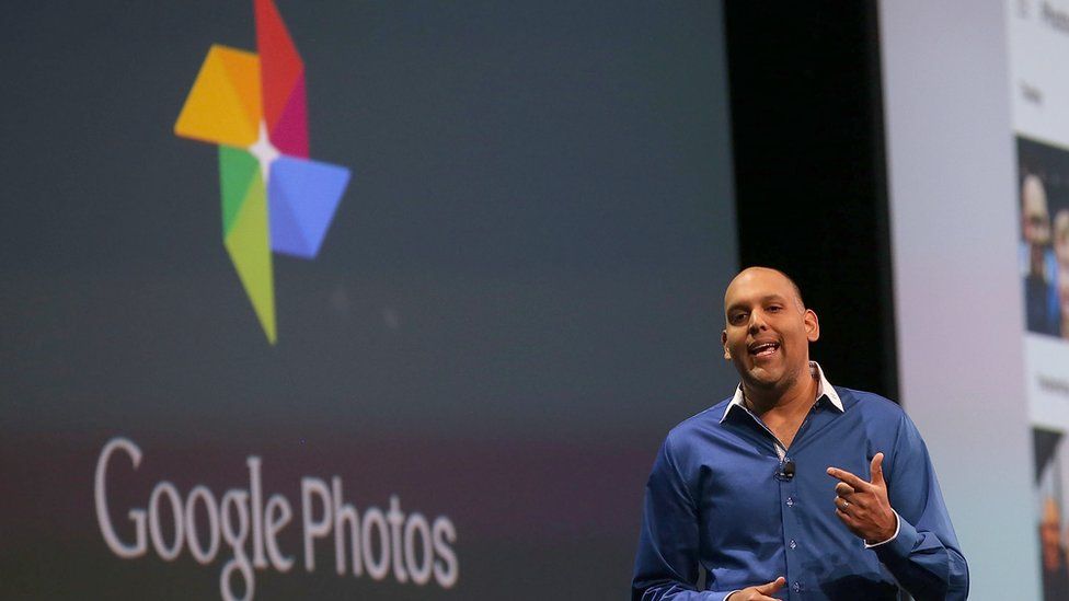 Anil Sabharwal stands on stage announcing Google Photos in May 2018
