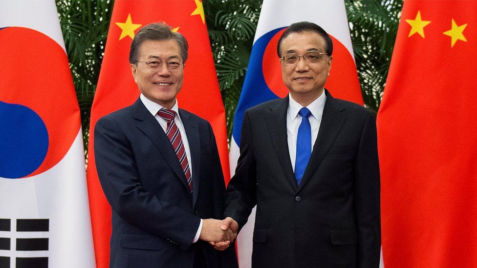 South Korea's Moon Jae-in and China's Li Keqiang shake hands