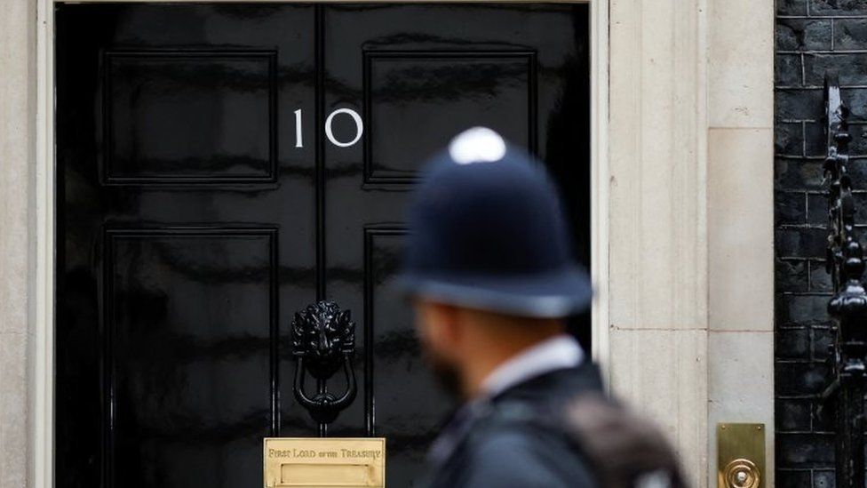 A police officer stands guard outside the 10 Downing Street, in London