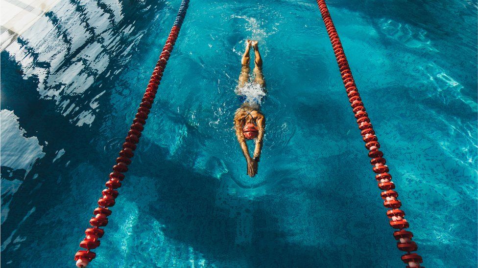 A woman swimming in a pool lane
