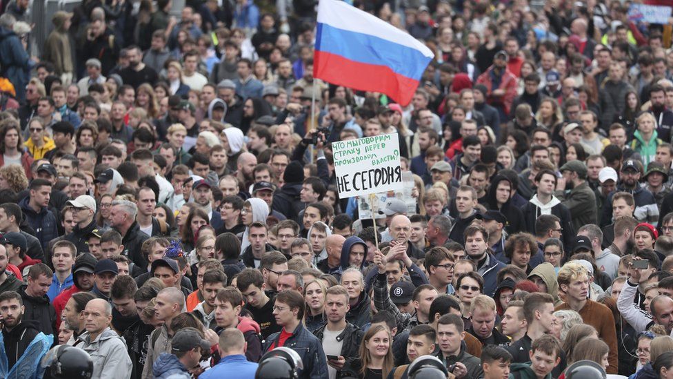 Protesters hold a Russian flag during a demonstration in Moscow on 10 August 2019