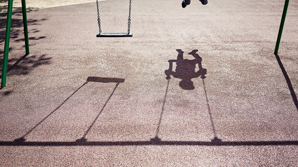 Shadow of a child on a swing