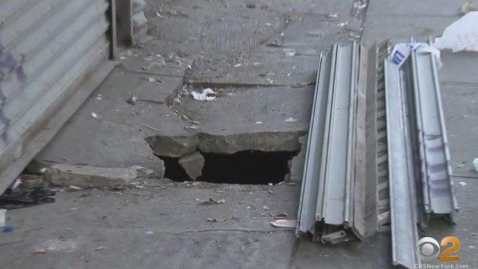 A picture of the pavement that a man fell through in New York