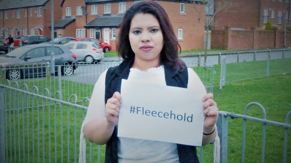 Halima Ali holding a sign saying #Fleecehold