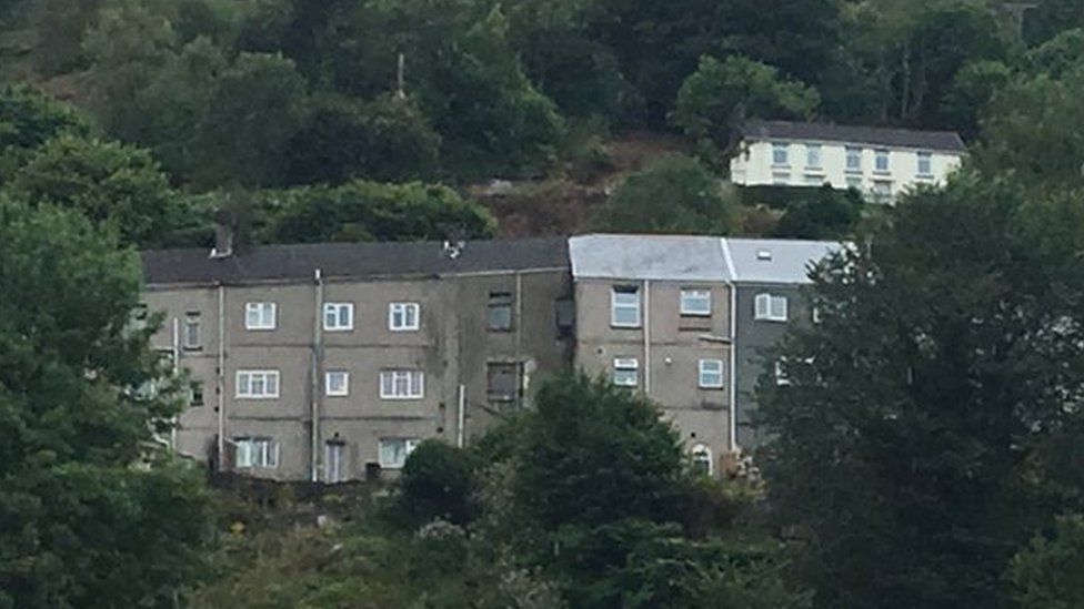 The row of houses stand on a hillside in the Swansea Valley