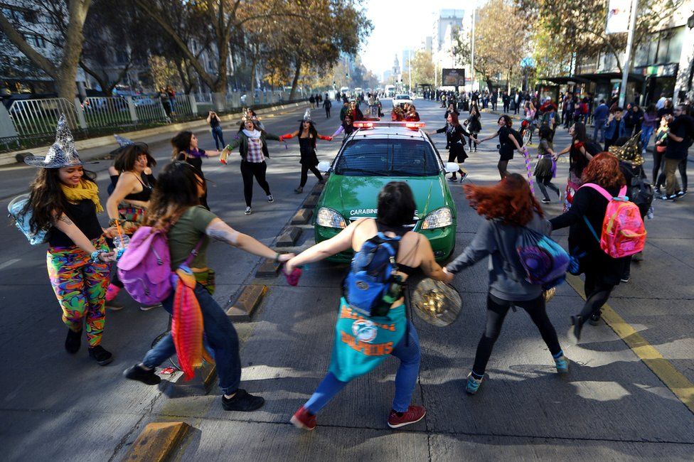 Demonstrators surround a police vehicle during a march demanding an end to sexism and gender violence in Santiago, Chile June 6, 2018