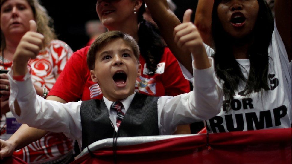 A young participant gestures during a campaign rally with President Donald Trump in Estero, Florida