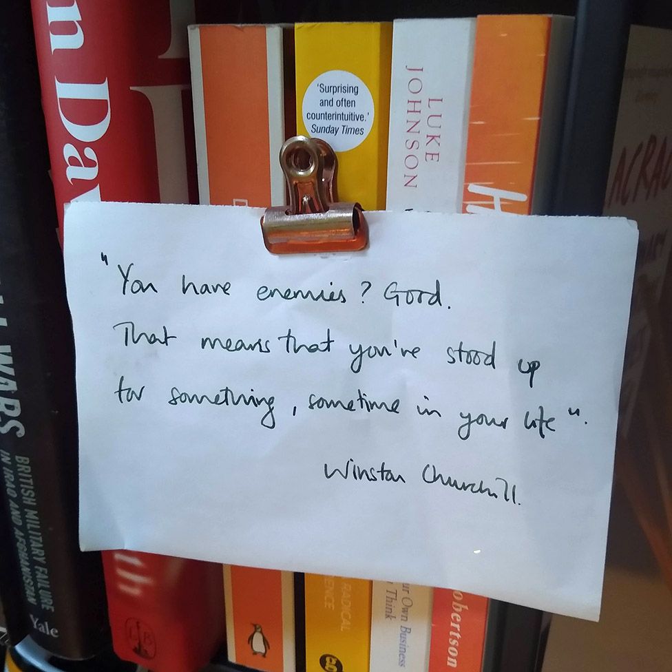 A note stuck to the book case