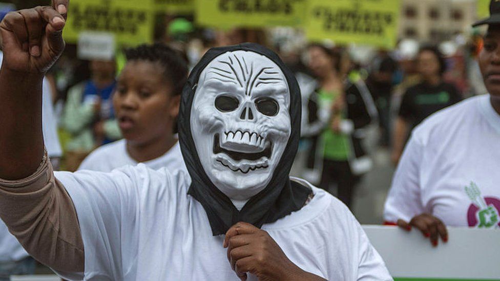 Protester in South Africa wearing a skull mask