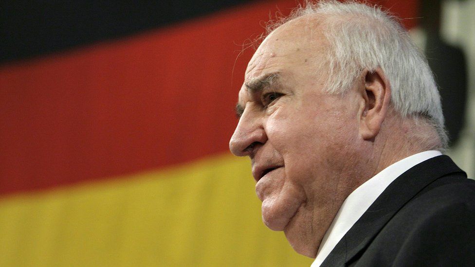 Helmut Kohl in front of a German flag