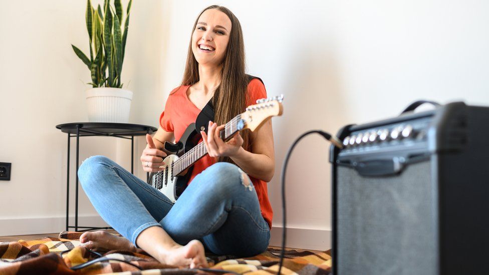 Woman playing guitar