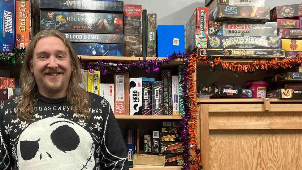 Game On owner Graham Peackock standing in front of shelves of board games