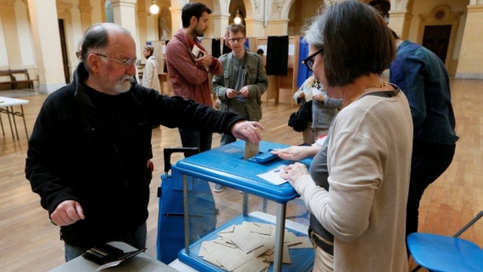 A man votes in the second round of 2017 French presidential election at a polling station in Lyon, France, May 7, 2017.