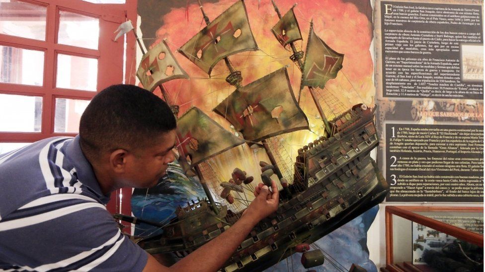 A picture made available on 07 December 2015 shows a man with an illustration of the Spanish galleon San Jose during a press conference to announce the finding of the shipwreck in the Colombian Caribbean, in Cartagena, Colombia, 05 December 2015