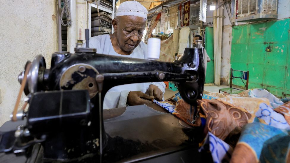 A tailor working at a sewing machine in Khartoum, Sudan - Friday 29 April 2022