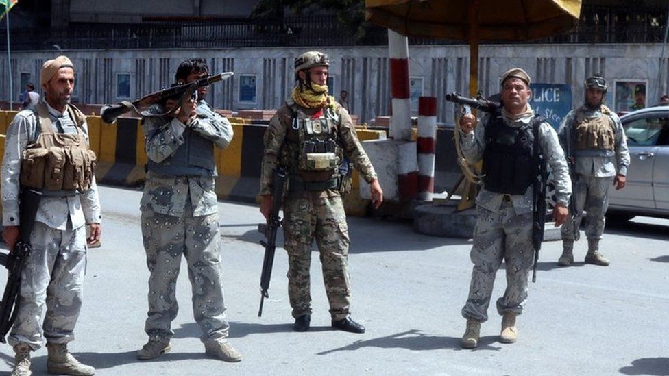 Afghan security officials stand guard at a checkpoint in Kabul, Afghanistan, 15 August 2021