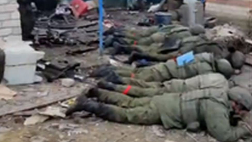 Soldiers lying face down on ground
