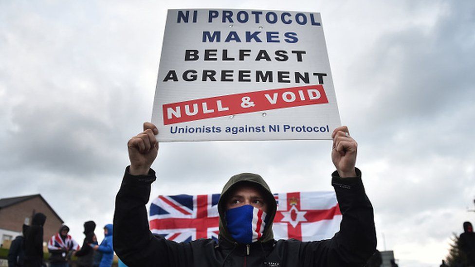 Loyalists hold up placards during an anti-Northern Ireland Protocol protest